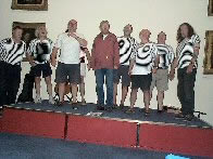 On stage at Swansea Museum Swansea Shanty Festival '05 (we're not wearing 'Op-Art' shirts, it's something the photo process has done!)